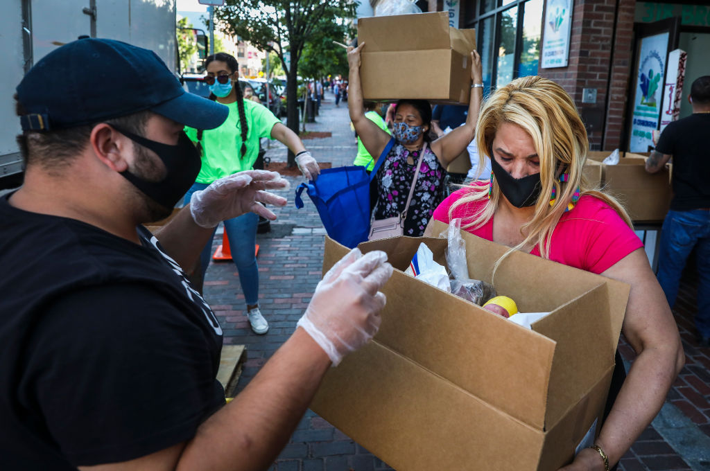 Volunteers package food at a food bank.