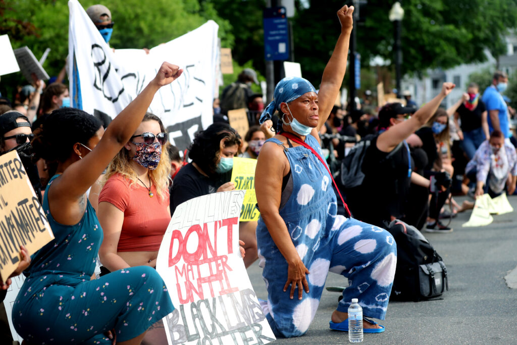 Activists kneel during a protest.
